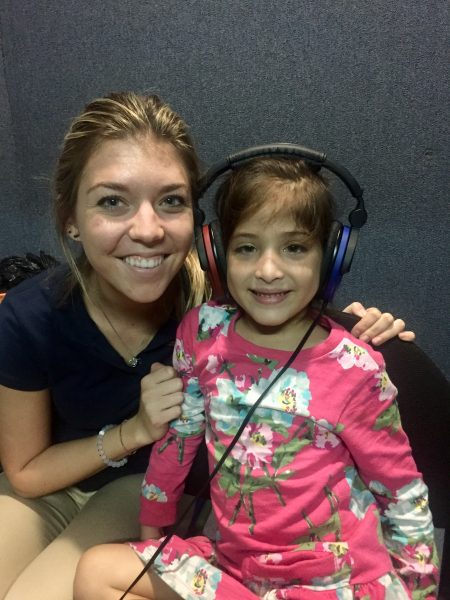 Audiology student Kasia Baginski with one of the children who received a hearing assessment in Nicaragua.