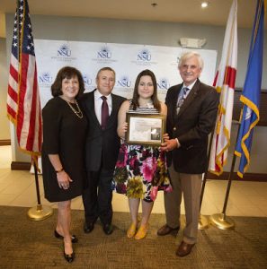 Helen Villarreal, winner in the Art Category, is congratulated by Barbra (left) and Craig Weiner, of the Holocaust Learning and Education Fund, and NSU President George Hanbury.